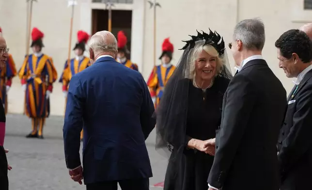 Britain's King Charles III and Queen Camilla arrive in the St. Damasus Courtyard at the Vatican for a state visit, where they will meet with Pope Leo XIV and pray with him in the Sistine Chapel, Thursday, Oct. 23, 2025. (AP Photo/Andrew Medichini)