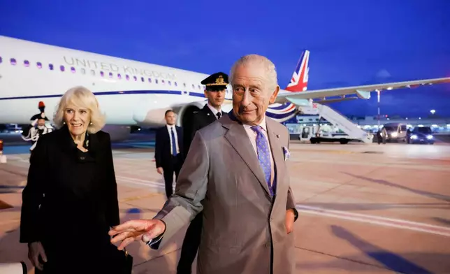 Britain's King Charles III and Queen Camilla arrive at Ciampino 31st Wing Airport in the outskirts of Rome, Wednesday, Oct. 22, 2025, a day before their state visit to the Vatican. (Cecilia Fabiano/ Lapresse via AP)