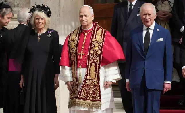 Pope Leo XIV, center, poses flanked by Britain's King Charles III and Queen Camilla in the St. Damasus Courtyard at the Vatican after a state visit and pray with him in the Sistine Chapel, Thursday, Oct. 23, 2025. (AP Photo/Andrew Medichini)