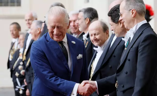 Britain's King Charles III arrives with Queen Camilla in the St. Damasus Courtyard at the Vatican for a state visit, where they will meet with Pope Leo XIV and pray with him in the Sistine Chapel, Thursday, Oct. 23, 2025. (Cecilia Fabiano/LaPresse via AP)