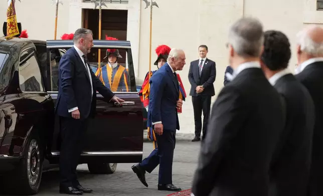 Britain's King Charles III and Queen Camilla arrive in the St. Damasus Courtyard at the Vatican for a state visit, where they will meet with Pope Leo XIV and pray with him in the Sistine Chapel, Thursday, Oct. 23, 2025. (AP Photo/Andrew Medichini)