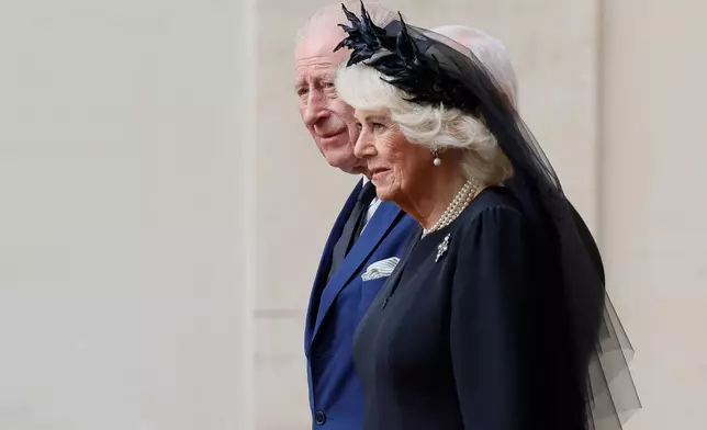 Britain's Queen Camilla, foreground arrives with King Charles III in the St. Damasus Courtyard at the Vatican for a state visit, where they will meet with Pope Leo XIV and pray with him in the Sistine Chapel, Thursday, Oct. 23, 2025. (Cecilia Fabiano/LaPresse via AP)