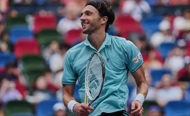 Arthur Rinderknech of France reacts after defeating Jiri Lehecka of the Czech Republic in the men's singles match of the Shanghai Masters tennis tournament at Qizhong Forest Sports City Tennis Center, in Shanghai, China, Wednesday, Oct. 8, 2025. (AP Photo/Andy Wong)