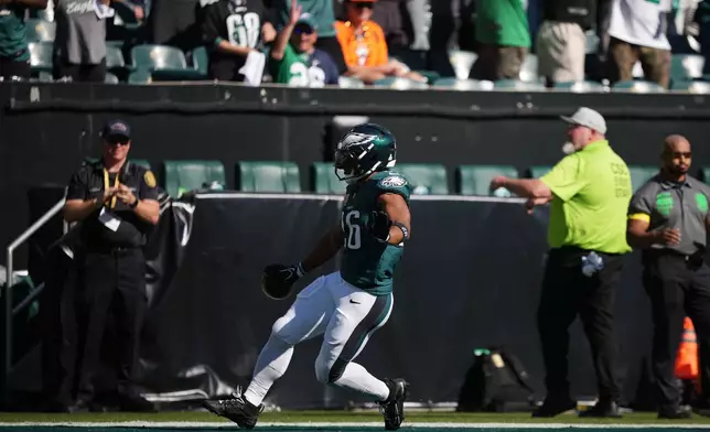 Philadelphia Eagles running back Saquon Barkley scores a touchdown during the second half of an NFL football game against the Denver Broncos on Sunday, Oct. 5, 2025, in Philadelphia. (AP Photo/Matt Slocum)