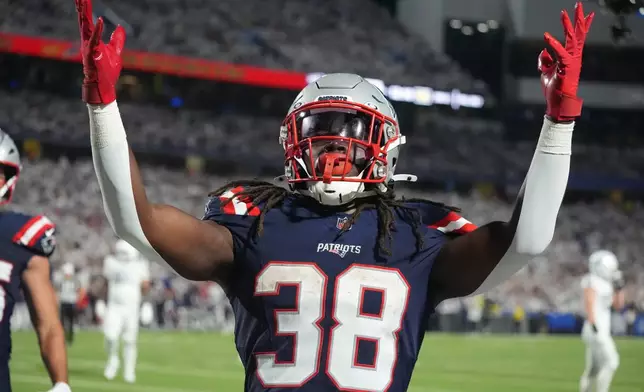 New England Patriots running back Rhamondre Stevenson (38) celebrates his touchdown against the Buffalo Bills during the second half of an NFL football game, Sunday, Sept. 5, 2025, in Orchard Park, N.Y. (AP Photo/Gene J. Puskar)