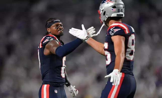 New England Patriots wide receiver Stefon Diggs, left, and New England Patriots tight end Hunter Henry, right, celebrate a play against the Buffalo Bills during the second half of an NFL football game, Sunday, Sept. 5, 2025, in Orchard Park, N.Y. (AP Photo/Adrian Kraus)