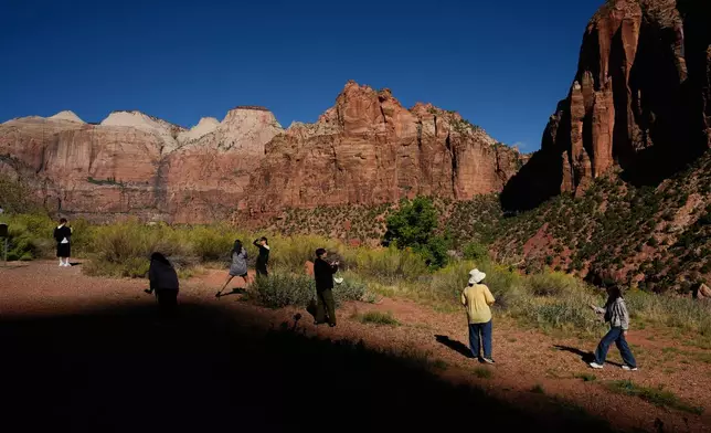People visit Zion National Park, Wednesday, Oct. 1, 2025, near Springdale, Utah. (AP Photo/John Locher)