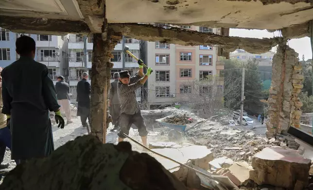 Residents remove debris from a house damaged by Wednesday's two drone strikes, in Kabul, Afghanistan, Thursday, Oct. 16, 2025. (AP Photo/Siddiqullah Alizai)
