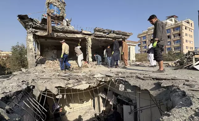 Residents remove debris from a house damaged by Wednesday's two drone strikes, in Kabul, Afghanistan, Thursday, Oct. 16, 2025. (AP Photo/Siddiqullah Alizai)