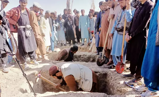 Locals dig graves for people killed in a cross-border airstrike by the Pakistani army in Afghanistan's eastern Paktika province, Saturday, Oct. 18, 2025. (AP Photo/Shafiqullah Mashaal)