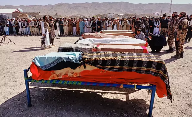 The bodies of victims of a Pakistani cross-border airstrike, including three local cricketers, are prepared for their funeral in the village of Khandaro in the Argun district of Afghanistan's eastern Paktika province, Saturday, Oct. 18, 2025. (AP Photo/Shafiqullah Mashaal)