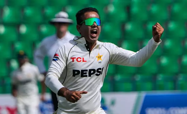 Pakistan's Noman Ali celebrates after taking the wicket of South Africa's Tony dy Zorzi during the third day of the first test cricket match between Pakistan and South Africa, in Lahore, Pakistan, Tuesday, Oct. 14, 2025. (AP Photo/K.M. Chaudary)