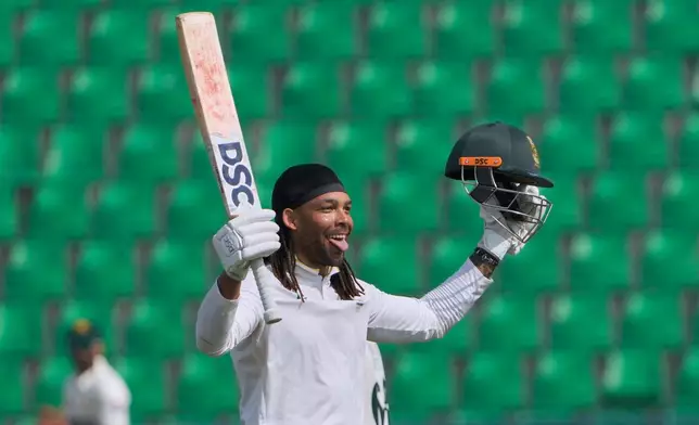 South Africa's Tony dy Zorzi celebrates after scoring century during the third day of the first test cricket match between Pakistan and South Africa, in Lahore, Pakistan, Tuesday, Oct. 14, 2025. (AP Photo/K.M. Chaudary)