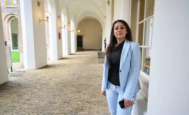 Palwasha Hamzad, who wants the Dutch election to be not about migration, but about tackling the chronic housing shortages in the Netherlands, poses for a portrait at the historic town hall in Haarlem, Netherlands, Friday, Oct. 17, 2025. (AP Photo/Peter Dejong)