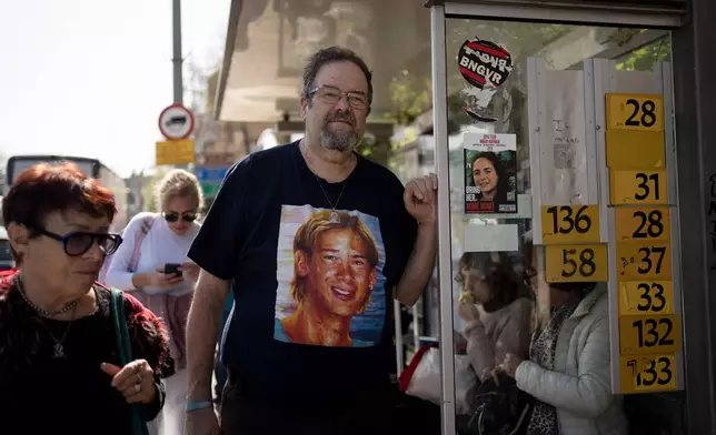FILE - Yossi Tzur stands at the bus stop near where his 17-year-old son, Assaf, was killed in a bus bombing in 2003 that killed 17 people in Haifa, Israel, Feb. 18, 2025. (AP Photo/Maya Alleruzzo, File)