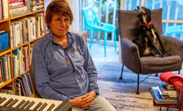 Tal Hartuv, who survived an attack by Palestinian militants armed with machetes in 2010, poses for a photo at her home in Zikhron Ya'akov, northern Israel, March 13, 2025. (AP Photo/Ariel Schalit)