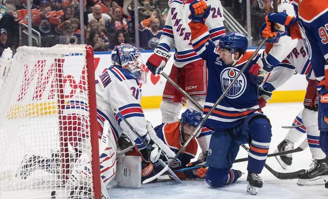 Edmonton Oilers' Matt Savoie, center right, celebrates after a goal against New York Rangers goalie Igor Shesterkin (31) during second-period NHL hockey game action in Edmonton, Alberta, Thursday, Oct. 30, 2025. (Jason Franson/The Canadian Press via AP)