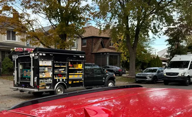 An FBI Evidence Response Team truck is seen idling in a Dearborn, Mich., neighborhood on Friday, Oct. 31, 2025. (AP Photo/Mike Householder)