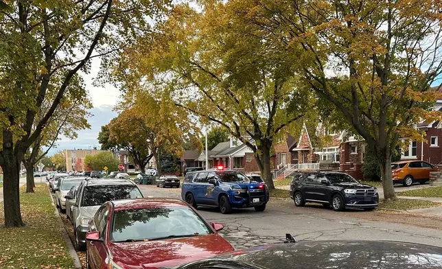 A Michigan State Police patrol vehicle is parked in a Dearborn, Mich., neighborhood on Friday, Oct. 31, 2025. (AP Photo/Mike Householder)