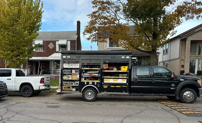 An FBI Evidence Response Team truck is seen idling in a Dearborn, Mich., neighborhood on Friday, Oct. 31, 2025. (AP Photo/Mike Householder)