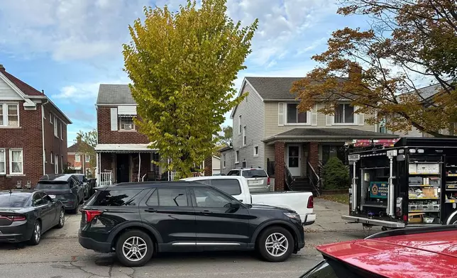 An FBI Evidence Response Team truck is seen idling in a Dearborn, Mich., neighborhood on Friday, Oct. 31, 2025. (AP Photo/Mike Householder)