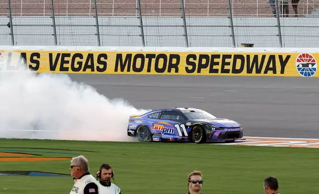Denny Hamlin performs a burnout after winning a NASCAR Cup Series auto race Sunday, Oct. 12, 2025, in Las Vegas. (AP Photo/Steve Marcus)
