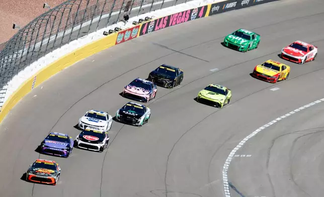 Drivers race out of Turn 4 during a NASCAR Cup Series auto race Sunday, Oct. 12, 2025, in Las Vegas. (AP Photo/Steve Marcus)