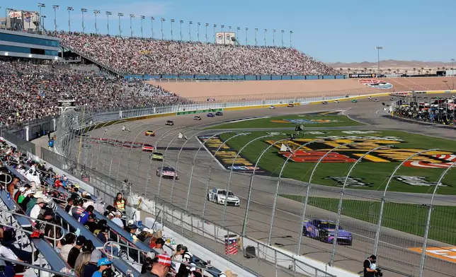 Drivers, including Denny Hamlin, lower right, compete on the front straightaway during a NASCAR Cup Series auto race Sunday, Oct. 12, 2025, in Las Vegas. (AP Photo/Steve Marcus)