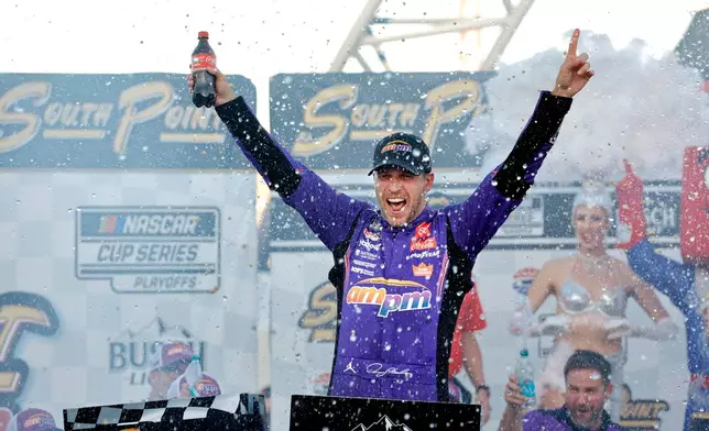 Denny Hamlin celebrates in victory lane after winning a NASCAR Cup Series auto race Sunday, Oct. 12, 2025, in Las Vegas. (AP Photo/Steve Marcus)