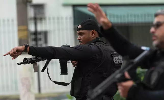 Police conduct an operation against alleged drug traffickers in the Complexo do Alemao favela where the criminal organization "Comando Vermelho" operates in Rio de Janeiro, Tuesday, Oct. 28, 2025. (AP Photo/Silvia Izquierdo)