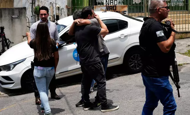 Police gather outside the Getulio Vargas Hospital where a colleague was brought after getting injured in an operation against alleged drug traffickers in the Complexo do Alemao favela where the criminal organization "Comando Vermelho" operates in Rio de Janeiro, Tuesday, Oct. 28, 2025. (AP Photo/Silvia Izquierdo)