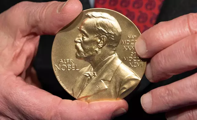 FILE - A close-up view of a Nobel Prize medal at the National Institutes of Health (NIH) in Bethesda, Md., Tuesday, Dec. 8, 2020. (AP Photo/Jacquelyn Martin, File)
