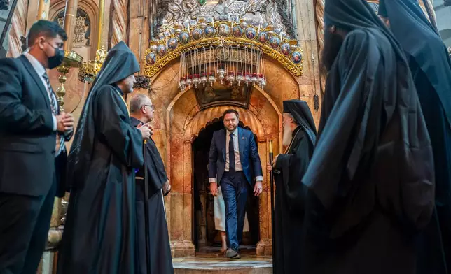 U.S. Vice President JD Vance, center, tours The Church of the Holy Sepulchre in the Old City of Jerusalem Thursday, Oct. 23, 2025. (Nathan Howard/Pool Photo via AP)
