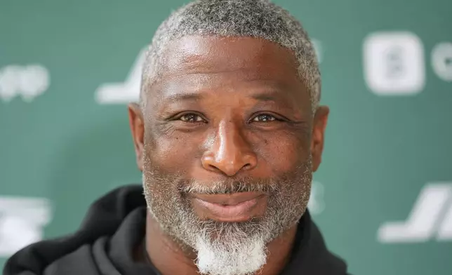 New York Jets head coach Aaron Glenn speaks during a press conference at an NFL football practice at The Grove in Watford, England, Friday, Oct. 10, 2025. (AP Photo/Kin Cheung)