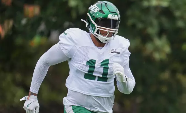 New York Jets linebacker Jermaine Johnson II (11) works out during NFL football practice at The Grove in Watford, England, Wednesday, Oct. 8, 2025. (AP Photo/Kin Cheung)