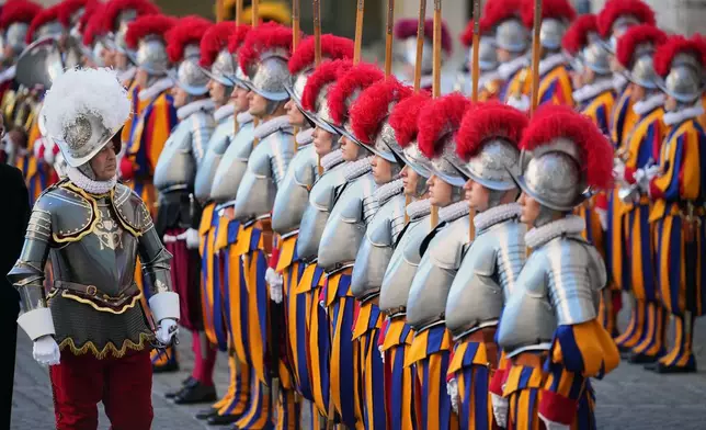 Pontifical Swiss Guard's 35th Commander Christoph Graf, left, review 27 Pontifical Swiss Guards cadets during their swearing in ceremony in the St. Damasus courtyard at the Vatican, Saturday, Oct. 4, 2025. (AP Photo/Andrew Medichini)