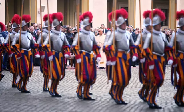 Pope Leo XIV attends the swearing in ceremony of 27 Pontifical Swiss Guards cadets in the St. Damasus Courtyard at the Vatican, Saturday, Oct. 4, 2025. (AP Photo/Andrew Medichini)
