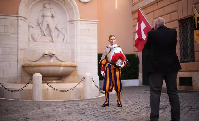 A Pontifical Swiss Guards has a photo taken ahead of his swearing in ceremony, at the Vatican, Saturday, Oct. 4, 2025. (AP Photo/Andrew Medichini)