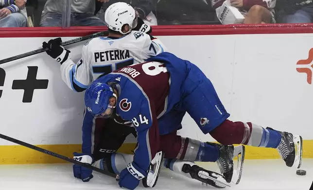 Colorado Avalanche defenseman Brent Burns (84) checks Utah Mammoth right wing JJ Peterka, back, in the third period of an NHL hockey game Thursday, Oct. 9, 2025, in Denver. (AP Photo/David Zalubowski)