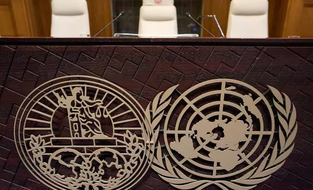 The seat of Presiding Judge Yuji Iwasawa, center, and the World Court logo are seen prior the reading of the advisory opinion of the International Court of Justice on what Israel must do to ensure humanitarian aid reaches Palestinians in Gaza and the occupied West Bank, in The Hague, Netherlands, Wednesday, Oct. 22, 2025. (AP Photo/Peter Dejong)