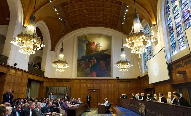 Presiding Judge Yuji Iwasawa, third from right, starts reading the advisory opinion of the International Court of Justice on what Israel must do to ensure humanitarian aid reaches Palestinians in Gaza and the occupied West Bank, in The Hague, Netherlands, Wednesday, Oct. 22, 2025. (AP Photo/Peter Dejong)