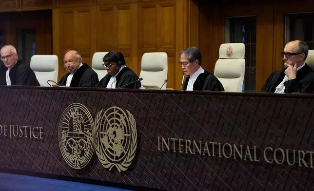 Presiding Judge Yuji Iwasawa, second right, starts reading the advisory opinion of the International Court of Justice on what Israel must do to ensure humanitarian aid reaches Palestinians in Gaza and the occupied West Bank, in The Hague, Netherlands, Wednesday, Oct. 22, 2025. (AP Photo/Peter Dejong)