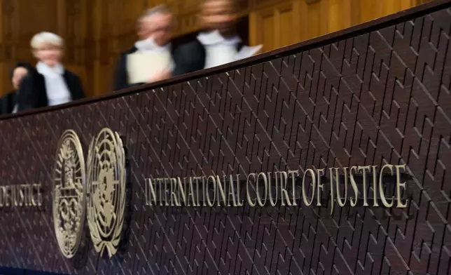 Judges walk to their seats before reading the advisory opinion of the International Court of Justice on what Israel must do to ensure humanitarian aid reaches Palestinians in Gaza and the occupied West Bank, in The Hague, Netherlands, Wednesday, Oct. 22, 2025. (AP Photo/Peter Dejong)
