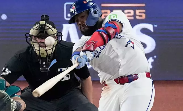 Toronto Blue Jays' Vladimir Guerrero Jr. connects for a solo home run against the Seattle Mariners during the fifth inning in Game 6 of baseball's American League Championship Series, Sunday, Oct. 19, 2025, in Toronto. (AP Photo/David J. Phillip)