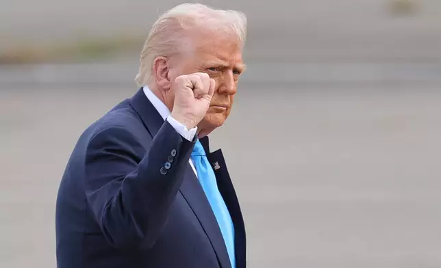 U.S. President Donald Trump walks towards Air Force One at Haneda Airport in Tokyo for his departure to South Korea, Wednesday, Oct. 29, 2025. (Kim Kyung-Hoon/Pool Photo via AP)