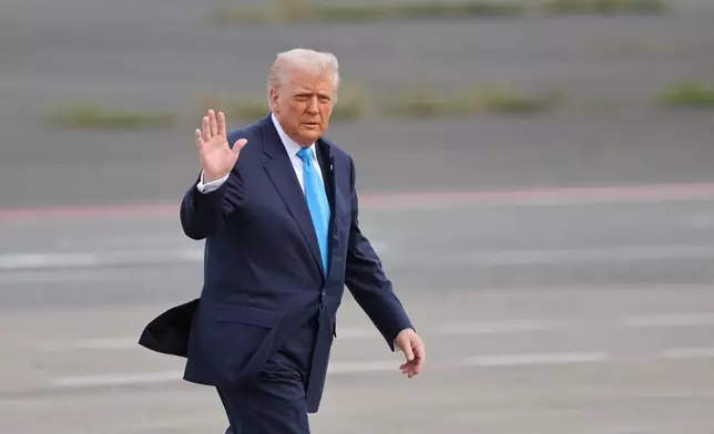 U.S. President Donald Trump walks towards Air Force One at Haneda Airport in Tokyo for his departure to South Korea, Wednesday, Oct. 29, 2025. (Kim Kyung-Hoon/Pool Photo via AP)