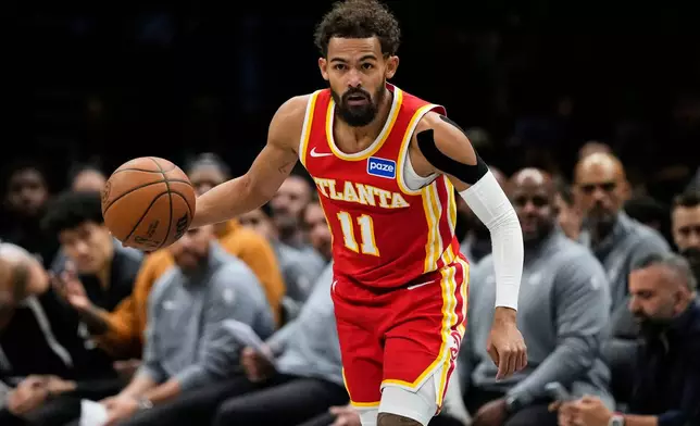 Atlanta Hawks' Trae Young (11) looks to pass during the first half of an NBA basketball game against the Brooklyn Nets Wednesday, Oct. 29, 2025, at Barclays Center in New York. (AP Photo/Frank Franklin II)
