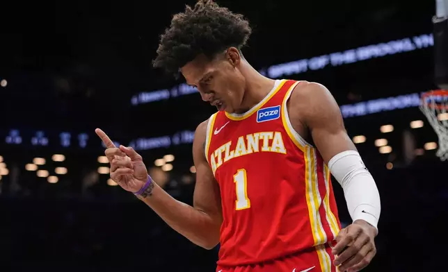 Atlanta Hawks' Jalen Johnson (1) gestures after drawing a fould during the first half of an NBA basketball game against the Brooklyn Nets Wednesday, Oct. 29, 2025, at Barclays Center in New York. (AP Photo/Frank Franklin II)