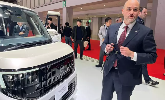 Nissan Chief Executive Ivan Espinosa speaks to reporters on the sidelines of the Tokyo Mobility Show set to open to the public Thursday, at Tokyo Big Sight in Tokyo, on Wednesday, Oct. 29, 2025. (AP Photo/Yuri Kageyama)