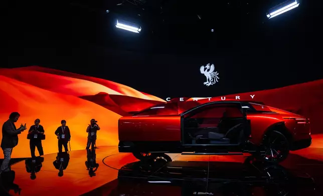 Members of the media and guests look at a Century's concept model during the press day of the Japan Mobility Show, in Tokyo, Thursday, Oct. 30, 2025. (AP Photo/Louise Delmotte)